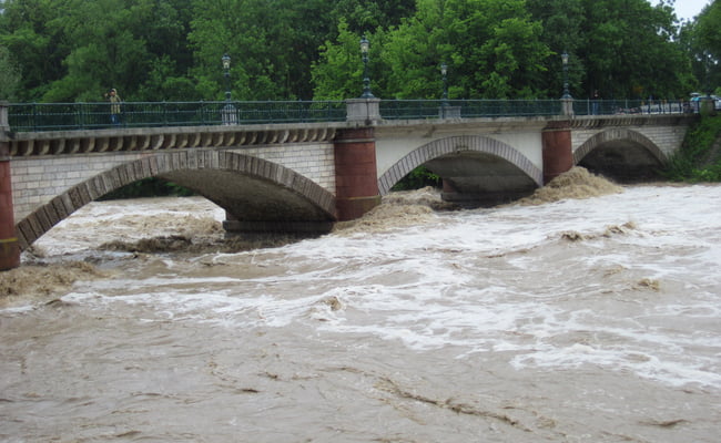 river flood overflowing near bridge