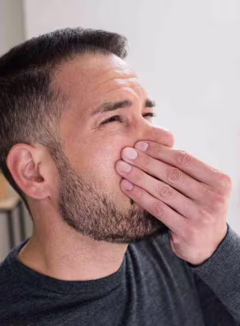 man smelling a bad odor in Metairie home