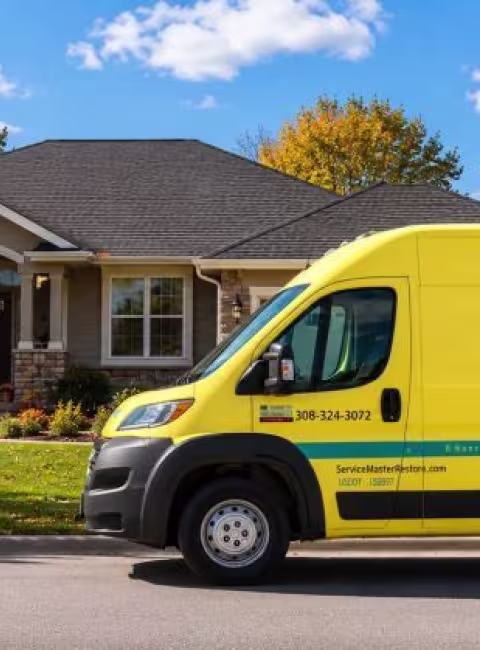 ServiceMaster Van parked in front of home on a fall day