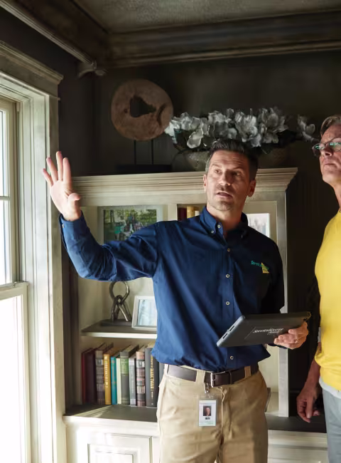 servicemaster restore technician and a homeowner assessing and discussing fire damage