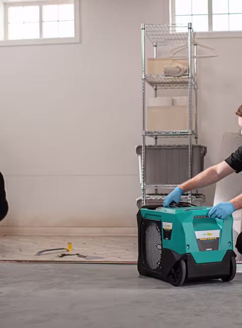 servicemaster restore technicians setting up structural drying equipment