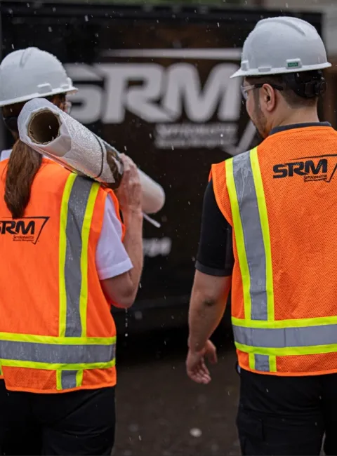 ServiceMaster tech carrying construction material