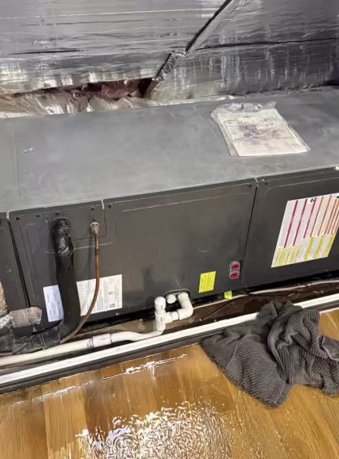 HVAC system leak with puddles on the wood floor