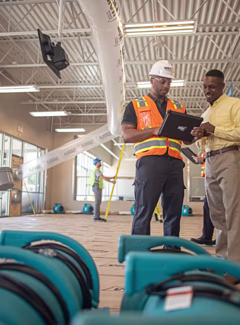 servicemaster restore technician guiding a business owner through restoration