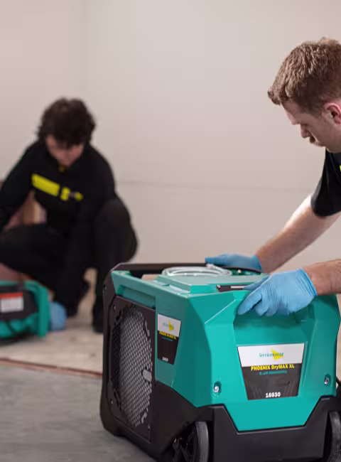technicians setting up drying equipment