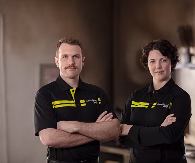 two servicemaster technicians in home with fire damage