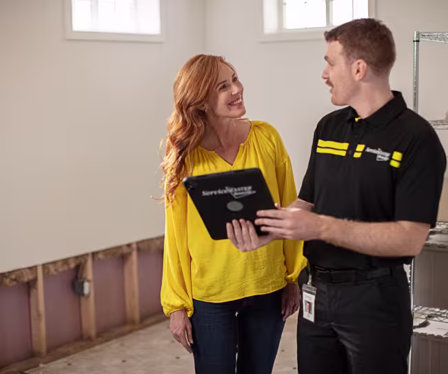 servicemaster restore technician discussing work with a homeowner