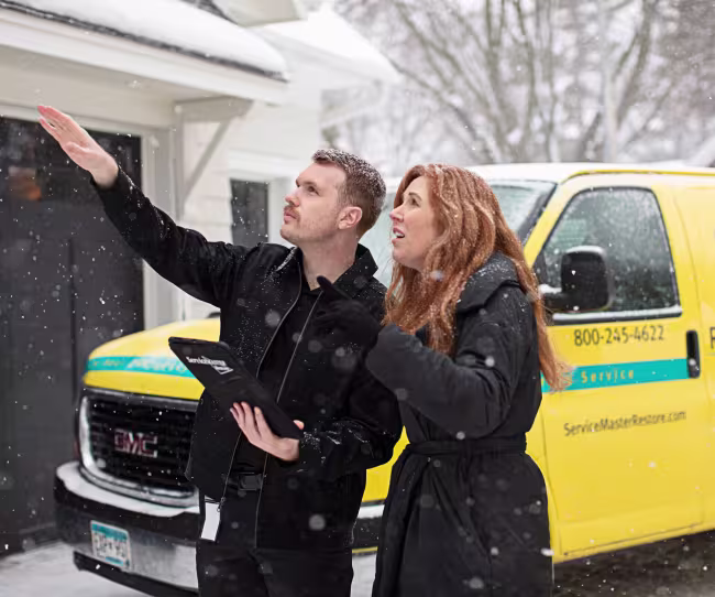 servicemaster restore technician talking with a homeowner about roof damage