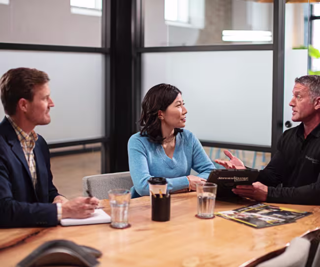 servicemaster rep and commercial clients talking at conference table