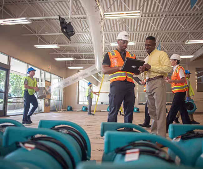 servicemaster restore technician guiding a business owner through restoration