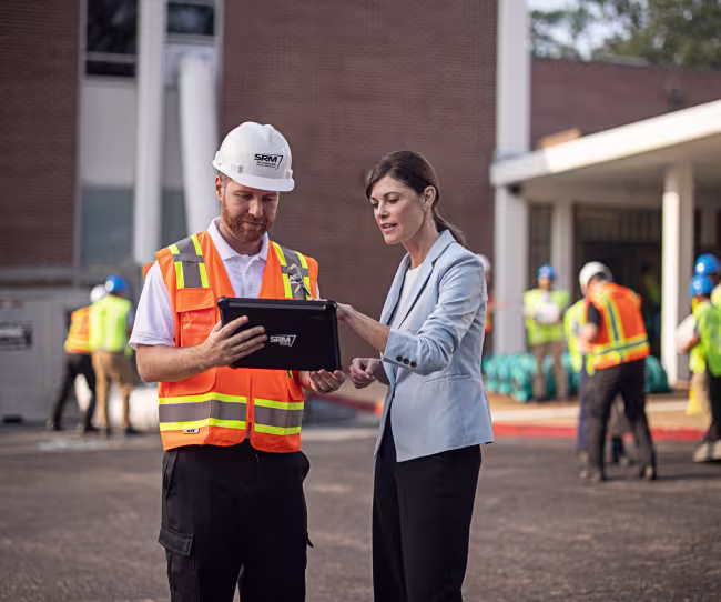 servicemaster technician shaking hands with a business owner outside of their business