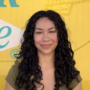 A girl in front of a yellow background