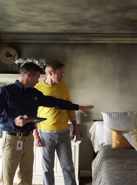 ServiceMaster Restoration By Simons fire manager discusses fire restoration process with home owner in Glencoe Illinois