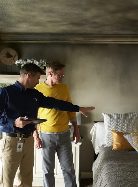 ServiceMaster Restoration By Simons fire manager discusses fire restoration process with home owner in Glencoe Illinois