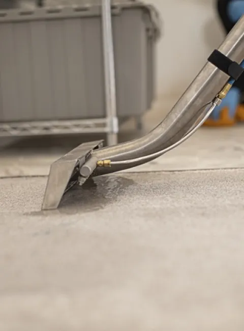 a servicemaster technicians cleans carpet after a water damage