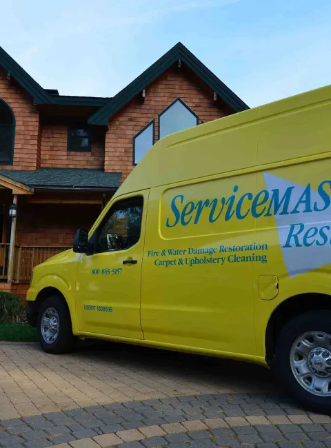 ServiceMaster Restore van in front of house