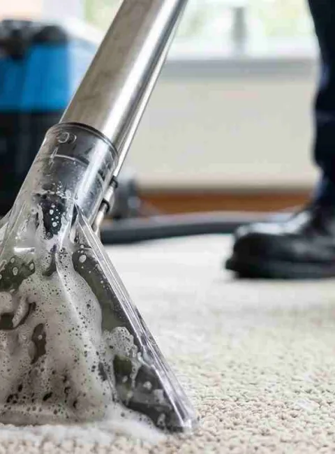man professionally cleaning carpet