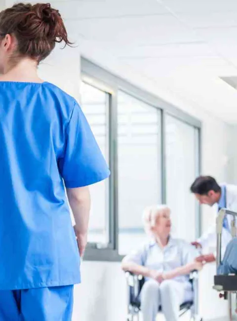 Hospital hallway with an pushing a hospital bed