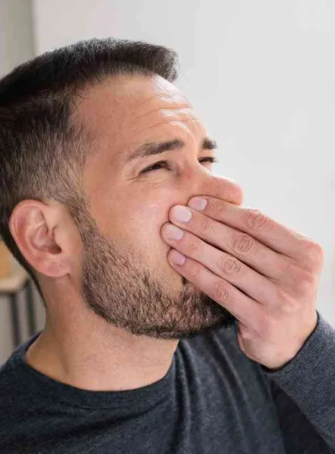man smelling a bad odor in Metairie home