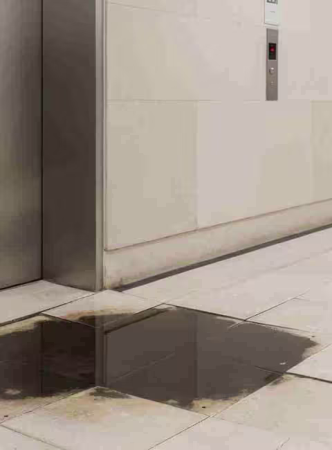 water damage at the base of a elevator