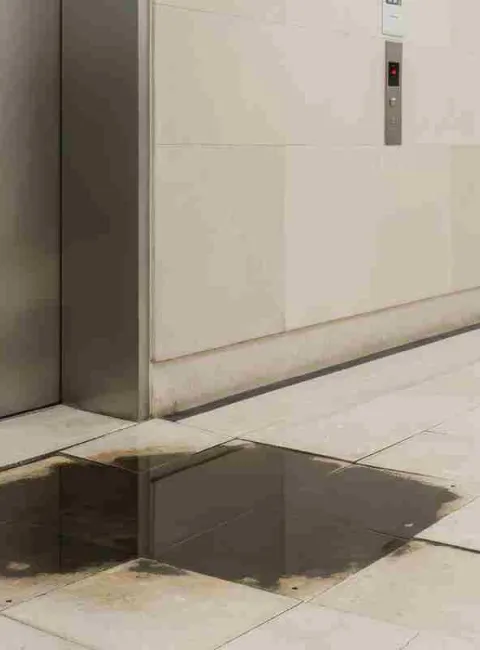 water damage at the base of a elevator
