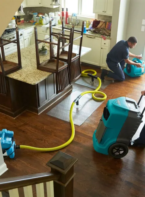 above angle of a servicemaster restore technician performing water extraction in a home