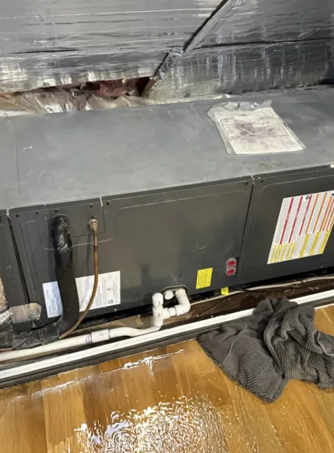HVAC system leak with puddles on the wood floor