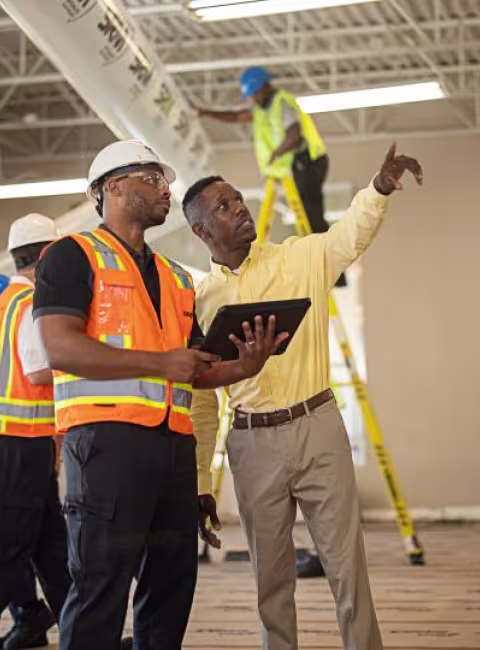 technician talking with business in their commercial space