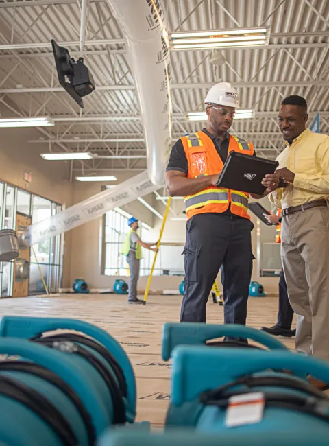 servicemaster restore technician guiding a business owner through restoration
