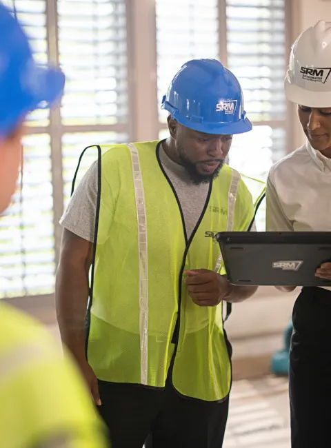 servicemaster restore technicians discussing a restoration plan in a business