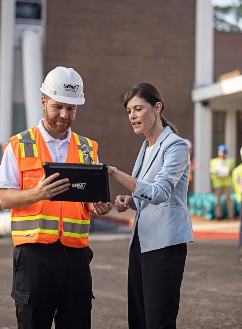 servicemaster technician shaking hands with a business owner outside of their business
