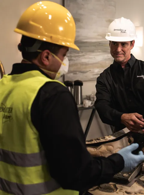 Two ServiceMaster technicians discussing fire damage