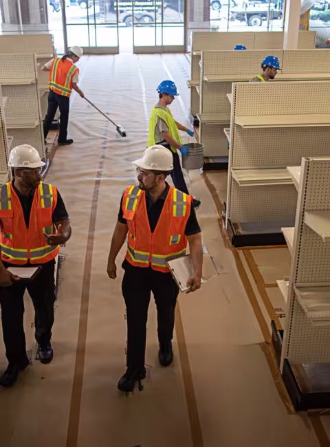 wide angle of a newly constructed commercial space with workers around