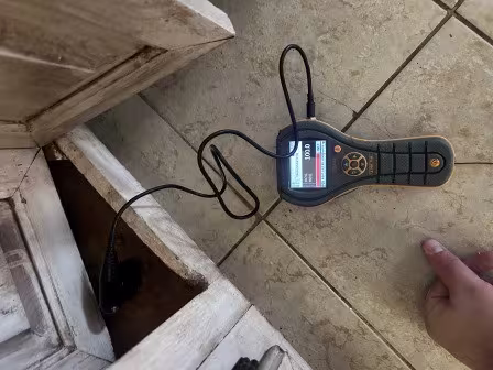 Moisture meter being used in cabinet cavity to measure moisture content