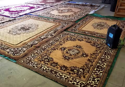 Area rugs laid out on floor ready to be cleaned
