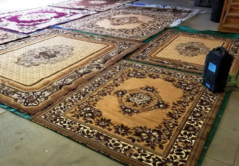 Area rugs laid out on floor ready to be cleaned