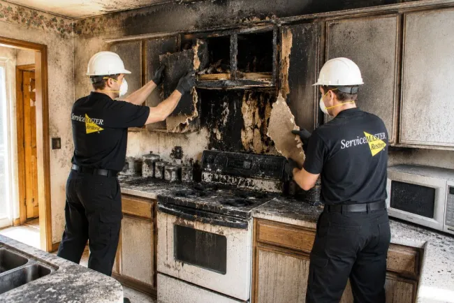 ServiceMaster technicians performing controlled demo of fire damaged kitchen in Dawson County, NE