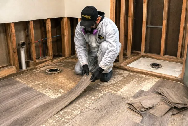 ServiceMaster tech performing demo work in bathroom affected by sewage