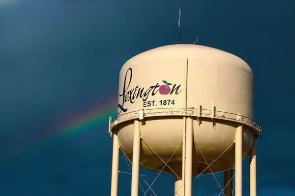 Lexington NE North Water Tower with dark blue sky and rainbow in the background