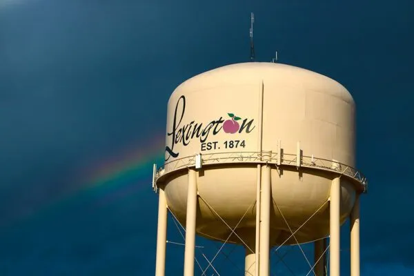 Lexington NE North Water Tower with dark blue sky and rainbow in the background