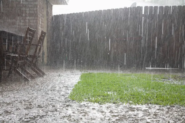 heavy rainfall flooding backyard causing water intrusion