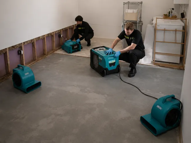 ServiceMaster Technicians setting up drying equipment 