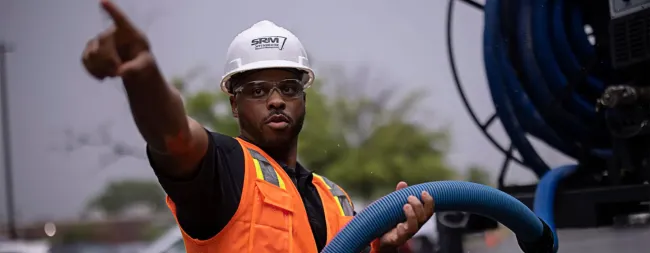 man_pointing_at_storm_damage