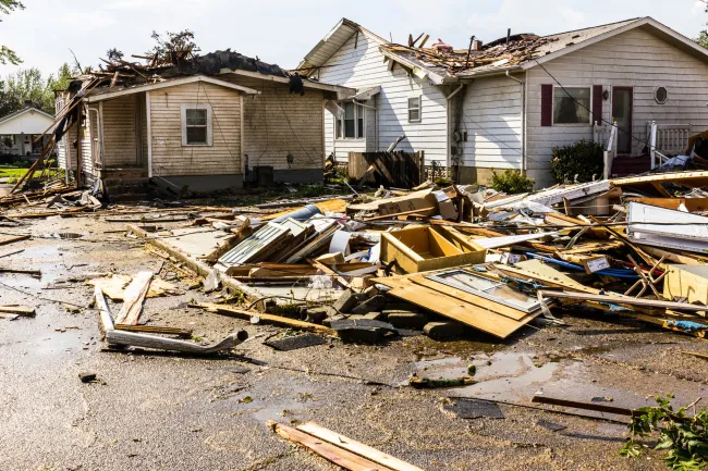 storm debris in front of homes