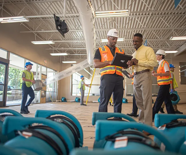 servicemaster restore technician guiding a business owner through restoration