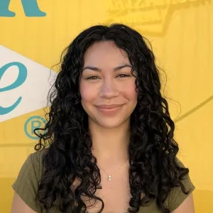 A girl in front of a yellow background