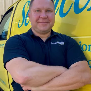 ServiceMaster employee in front of yellow van