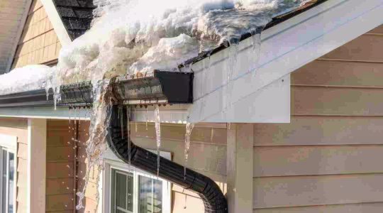 snow melting from a roof in the spring