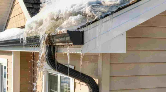 snow melting from a roof in the spring