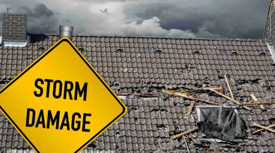 damaged roof due to storm creating water damage